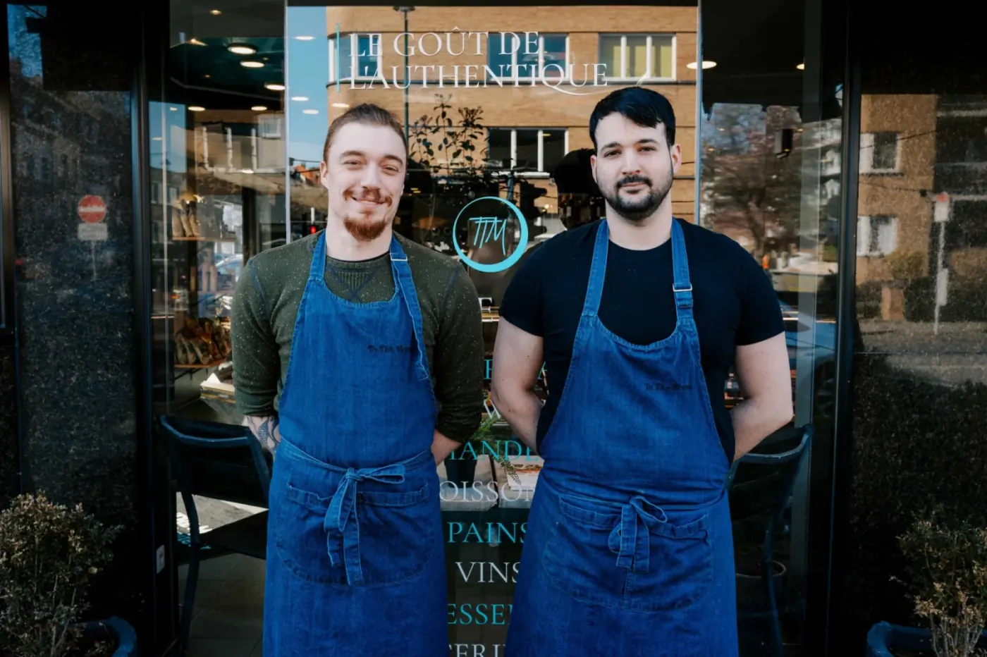 Jonathan and Brice, in their aprons, outside the shopfront